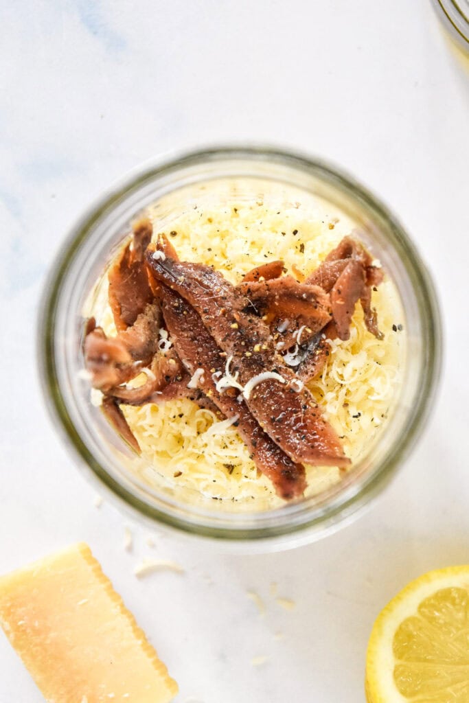 dressing ingredients for caesar dressing in a mason jar before blending.