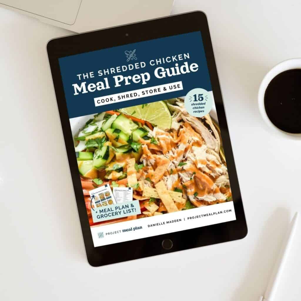 the shredded chicken meal prep guide ebook mockup on a table.