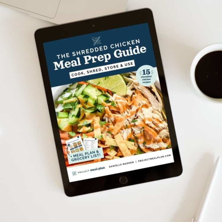 the shredded chicken meal prep guide ebook mockup on a table.