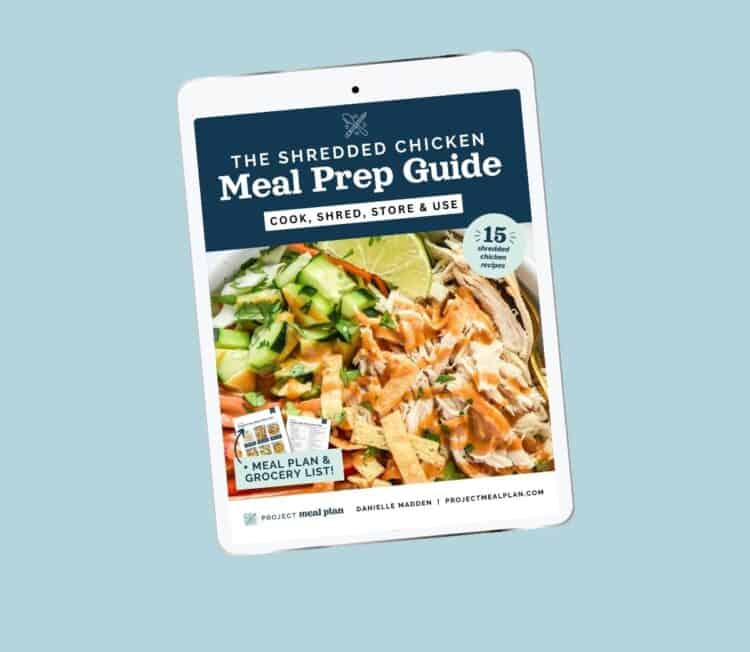 the shredded chicken meal prep guide on ipad with blue background.
