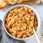 sloppy ground turkey white bean skillet dished up in a bowl with spoon.