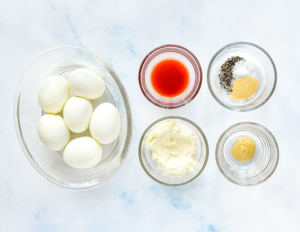 hard boiled eggs and other condiments on the counter before making.