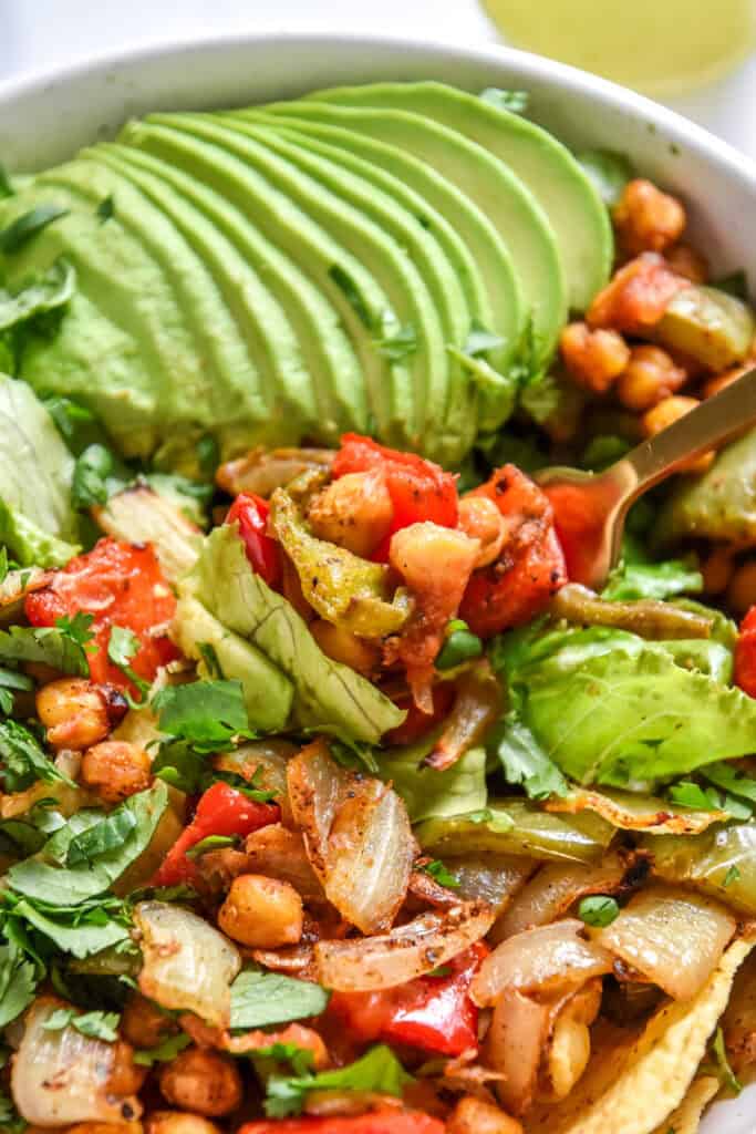 a bite of the roasted chickpea taco salad bowls on a fork.