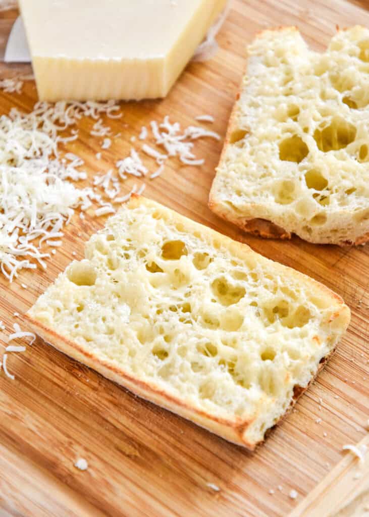 melted parmesan cheese on a sliced and toasted ciabatta bun.