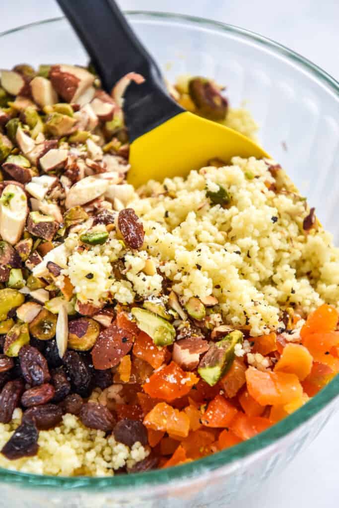 ingredients for the couscous mixture in a glass bowl before mixing it up.