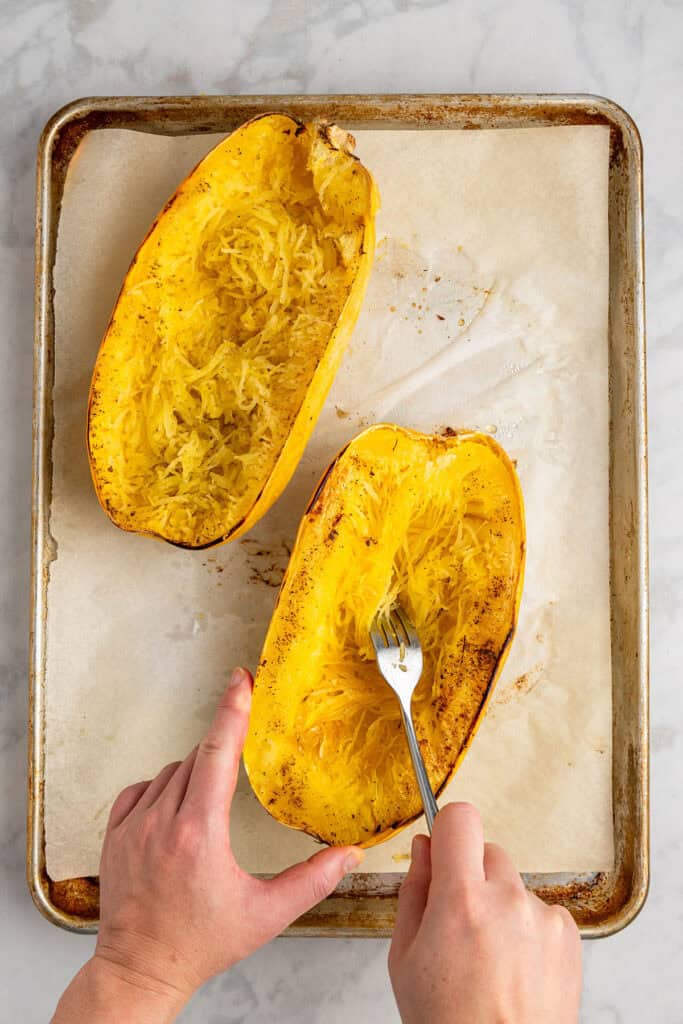 running a fork through spaghetti squash to get individual strands.