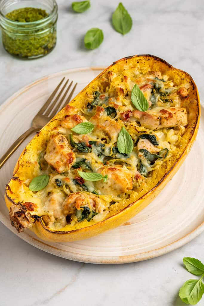 pesto chicken stuffed spaghetti squash on a sheet pan just baked.