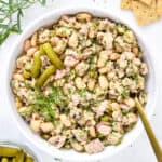 French-Style Tuna White Bean Salad in a bowl with fresh herbs and crackers on the side.
