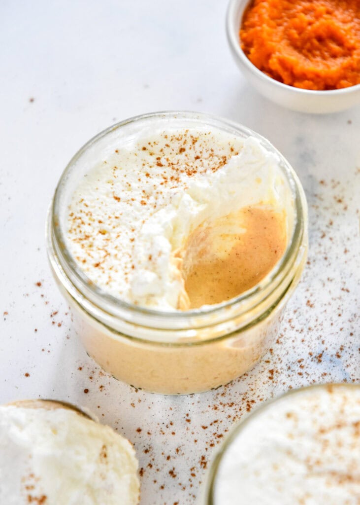 pumpkin spice whipped greek yogurt in a small glass mason jar.